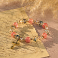 Pink Crystal & Multi-Faceted Bead Bracelet with Golden Crucifix